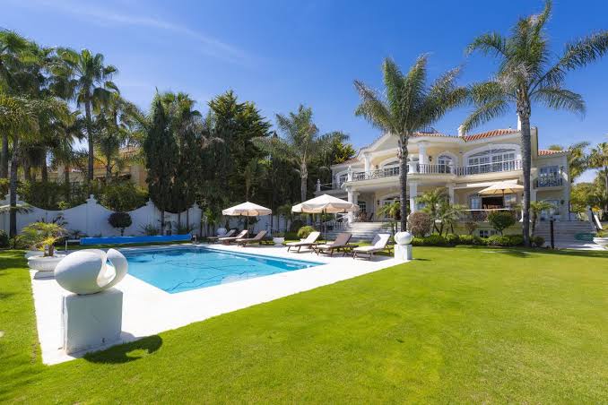Palm-lined villa with swimming pool