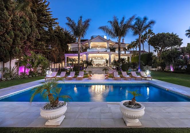 Large villa with pool at dusk
